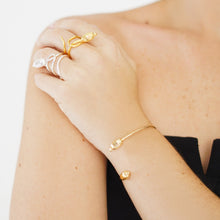 Load image into Gallery viewer, Seed Cuff Bracelet in 18K Gold Plated, handcrafted with an organic seed design, symbolizing growth and new beginnings, featuring an elegant open design.