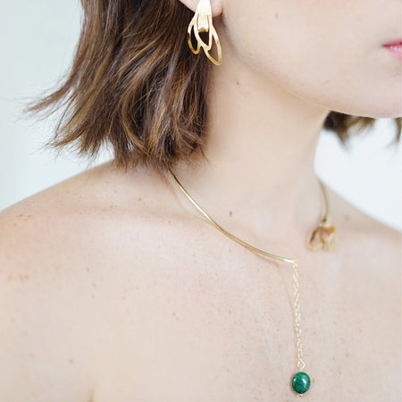 Handcrafted Vera Open Choker from the Seed Collection featuring a blooming seed design on one side and a vibrant malachite stone pendant on the other. Crafted in 18K gold plated over sterling silver, this necklace showcases a chic, elegant style suitable for any occasion.