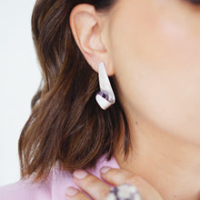 Cargar imagen en el visor de la galería, Handmade Maia Amethyst Drop Earrings featuring radiant purple gemstones gracefully wrapped in sterling silver lines and textures, creating a refined and elegant design.
