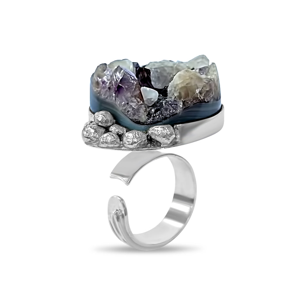 A handcrafted sterling silver cocktail ring featuring a singular amethyst stone with a unique cut, part of the exclusive One Piece Collection