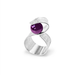 Handmade Maia Amethyst Ring featuring a radiant purple gemstone gracefully wrapped in sterling silver lines, creating a modern and sophisticated design.