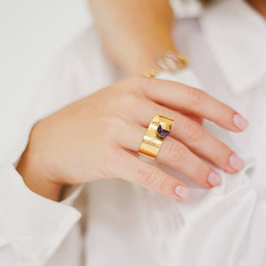 Handmade Maia Amethyst Ring featuring a radiant purple gemstone gracefully wrapped in lines and textures, creating a modern and sophisticated design. Made in in 18k gold plated over sterling.