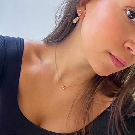 NATAL Birthstone Necklace for December with a medium-blue crystal inspired by Zircon, set in a 7mm 18K gold-plated charm on an fine adjustable gold-plated chain