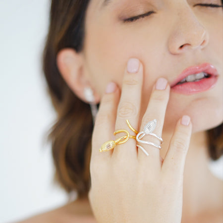 Handcrafted Seed Cocktail Ring in sterling silver and 18k gold plated, featuring an elegant, fluid design that wraps around the finger, culminating in a seed-shaped detail symbolizing growth and renewal